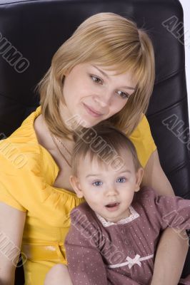 Mother and daughter sitting in a chair