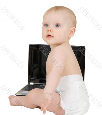 Baby sitting on a white background with laptop