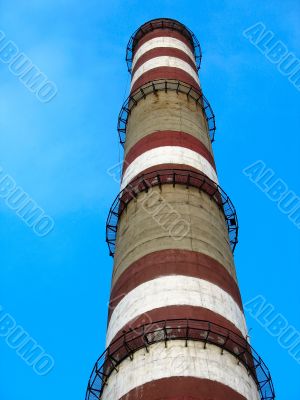 chimney with white and red lines over blue sky