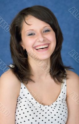 Laughing, happy girl on a blue background