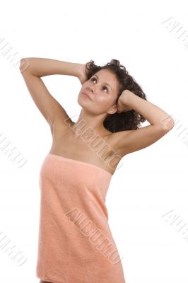 Woman wrapped in a peach-coloured bath towel.