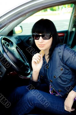 Beautiful young businesswoman in her car