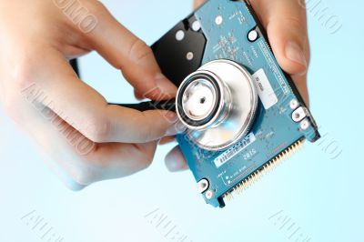 Doctor holding stethoscope against a  notebook hdd