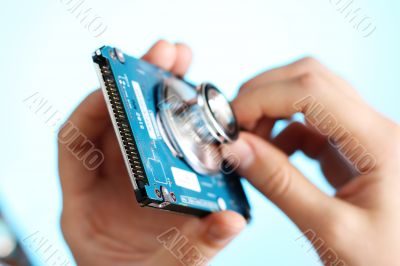 Doctor holding a stethoscope at notebook HDD