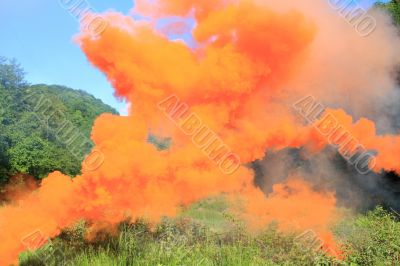 Orange smoke above a mountain glade
