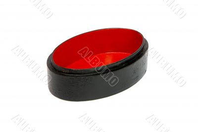 Empty oval black and red casket isolated