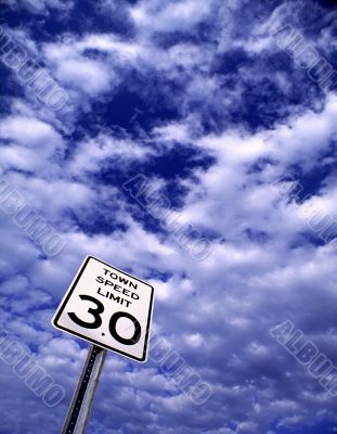 Speed Limit Sign Against Cloudy Sky