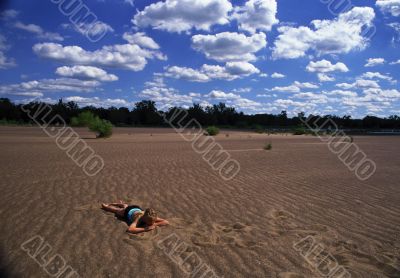 Beautiful woman resting on the sand