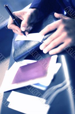 Man Writing at Counter