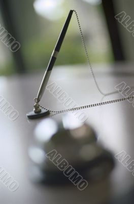 Pen and Bell on Desk Pen and Bell on Desk
