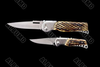 Two pen-knifes on a black background Two pen-knifes on a black background