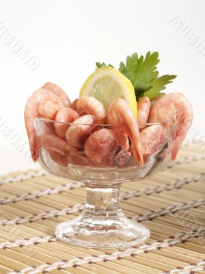bowl with shrimps on the table with lemon