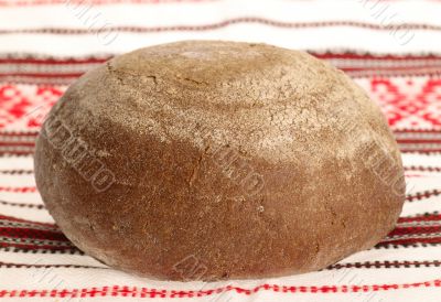 Delicious bread on traditional peasant textile background