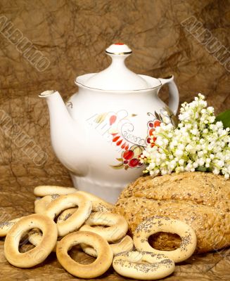 Delicious peasant bread with teapot and flowers Delicious peasant bread with teapot and flowers