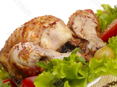 grilled chicken whole with vegetables on salad leafs