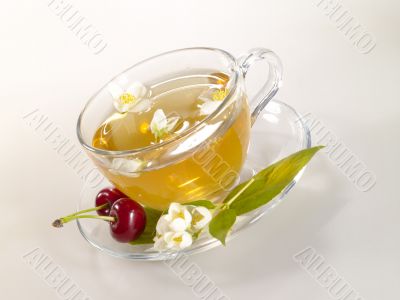 breakfast still-life. green tea with cherry and fresh jasmine