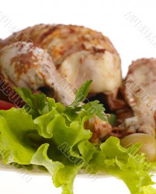 grilled chicken whole with vegetables on salad leafs