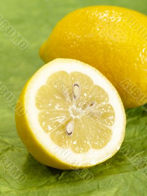fresh tasty lemon on green background