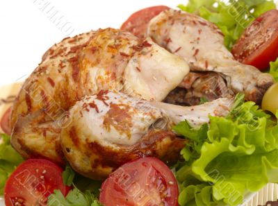 grilled chicken whole with vegetables on salad leafs