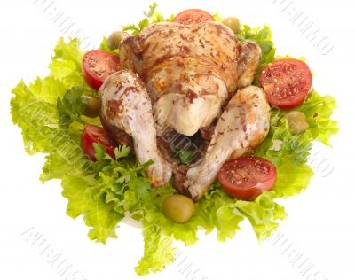 grilled chicken whole with vegetables on salad leafs