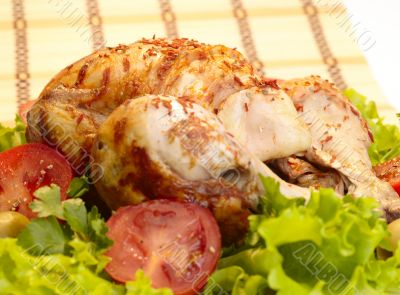 grilled chicken whole with vegetables on salad leafs