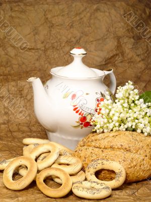 Delicious peasant bread with teapot and flowers Delicious peasant bread with teapot and flowers