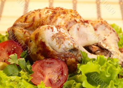 grilled chicken, whole with vegetables on salad leafs