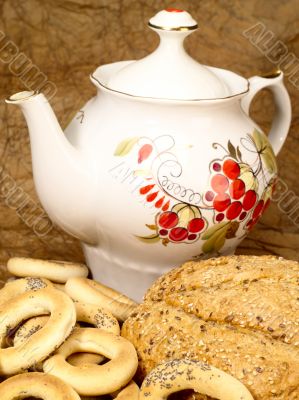 Delicious peasant bread with teapot and crisp