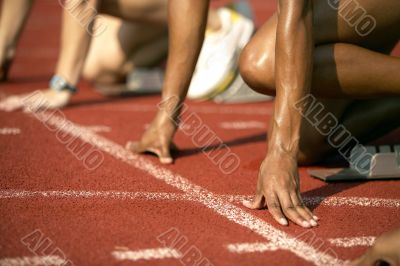 Focused Runner Positioned at Starting Block