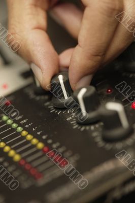 Disc Jockey Turning Dial on Sound Board