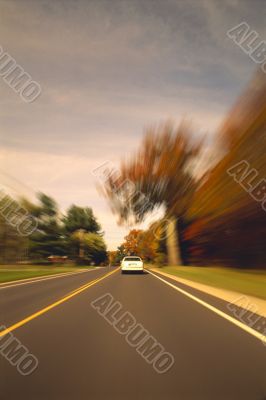 Automobile Driving Down Scenic Country Road