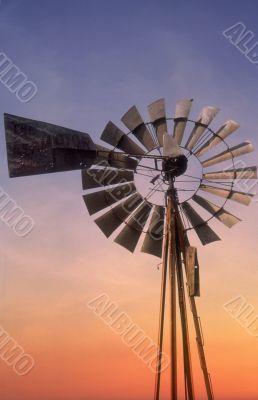 Windmill at sunset sky