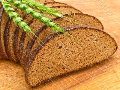 bread and grain at wooden board