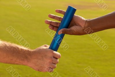 Hands Passing Baton at Sporting Event