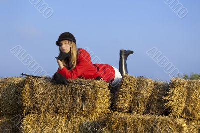 girl jockey / on a background of blue sky and hay