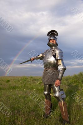 medieval knight in the field, and a rainbow