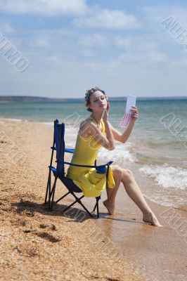 beautiful girl does make-up on the shore beautiful girl does make-up on the shore