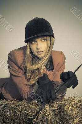 girl jockey / on a background of blue sky and hay