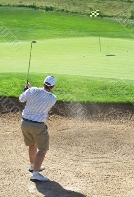 Golfer in the sand bunker