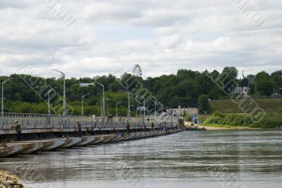 Pontoon-bridge on river for automobiles and people