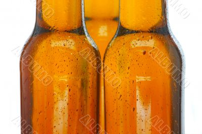 Upper part of three beer bottles