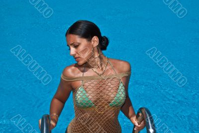 The beautiful model poses near pool