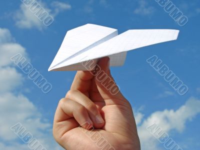 child hand with paper plane