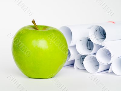 Green apple and sheet of paper on white background