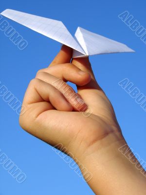 child hand with paper plane