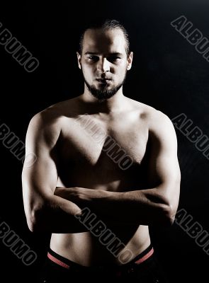 Muscular man over black