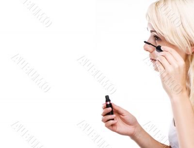 happy young woman using mascara