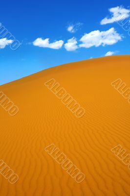 sand dunes and cumulus clouds