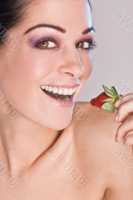 Image of beautiful girl holding strawberry enjoy