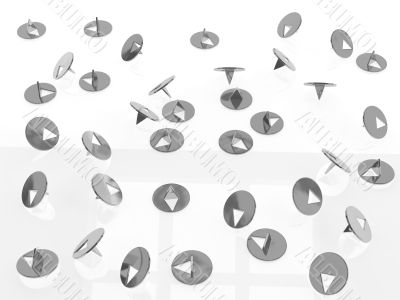 metallic thumbtacks (drawing pins) on white background